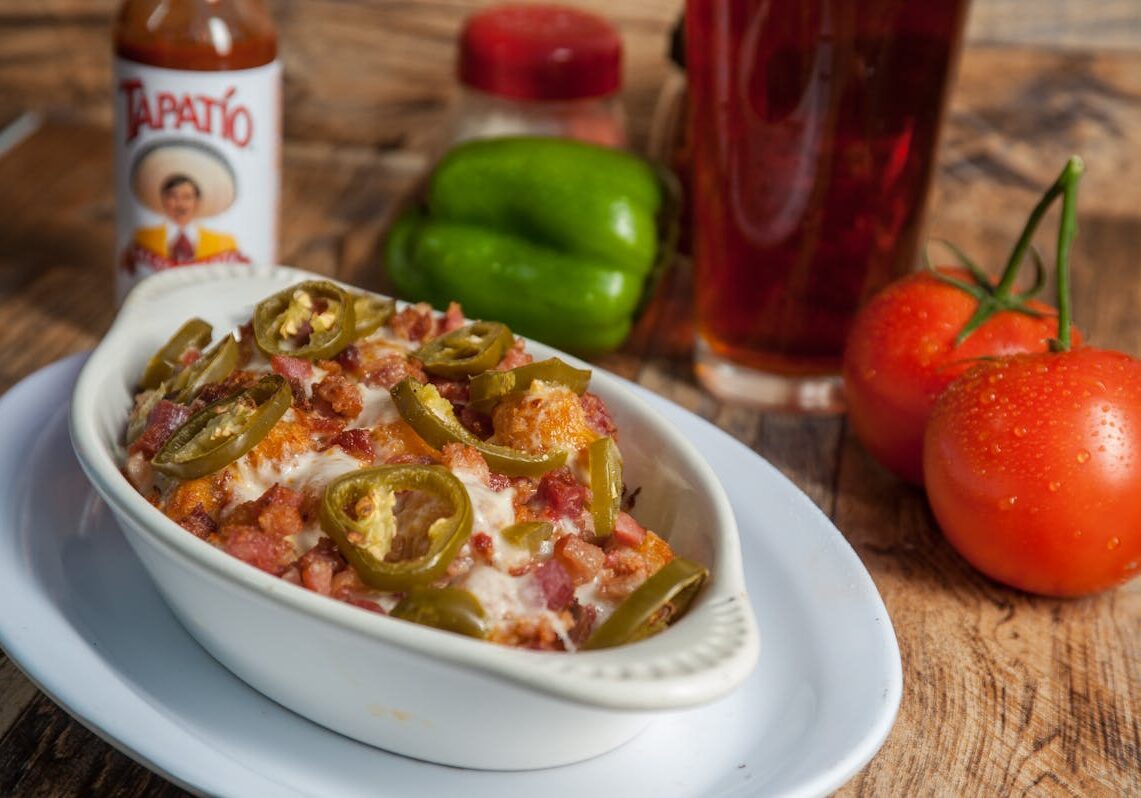 asset 14 A bowl of loaded nachos with jalapeños and melted cheese.