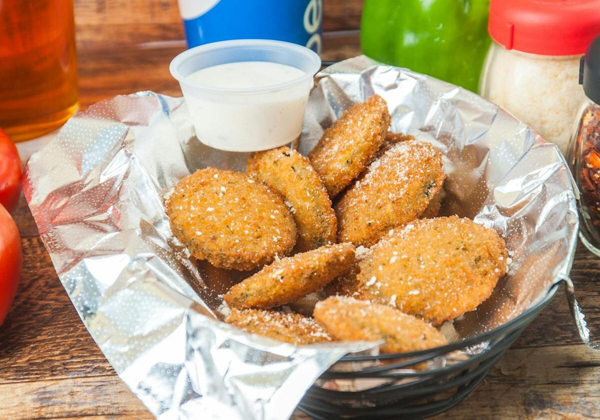 asset 16 Basket of crispy chicken nuggets with dipping sauce.