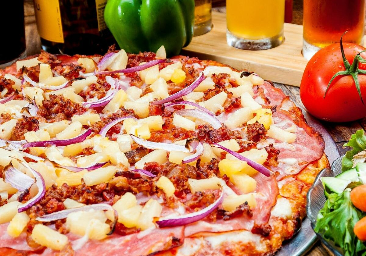 asset 26 A freshly baked pizza topped with cheese, ham, and bacon.