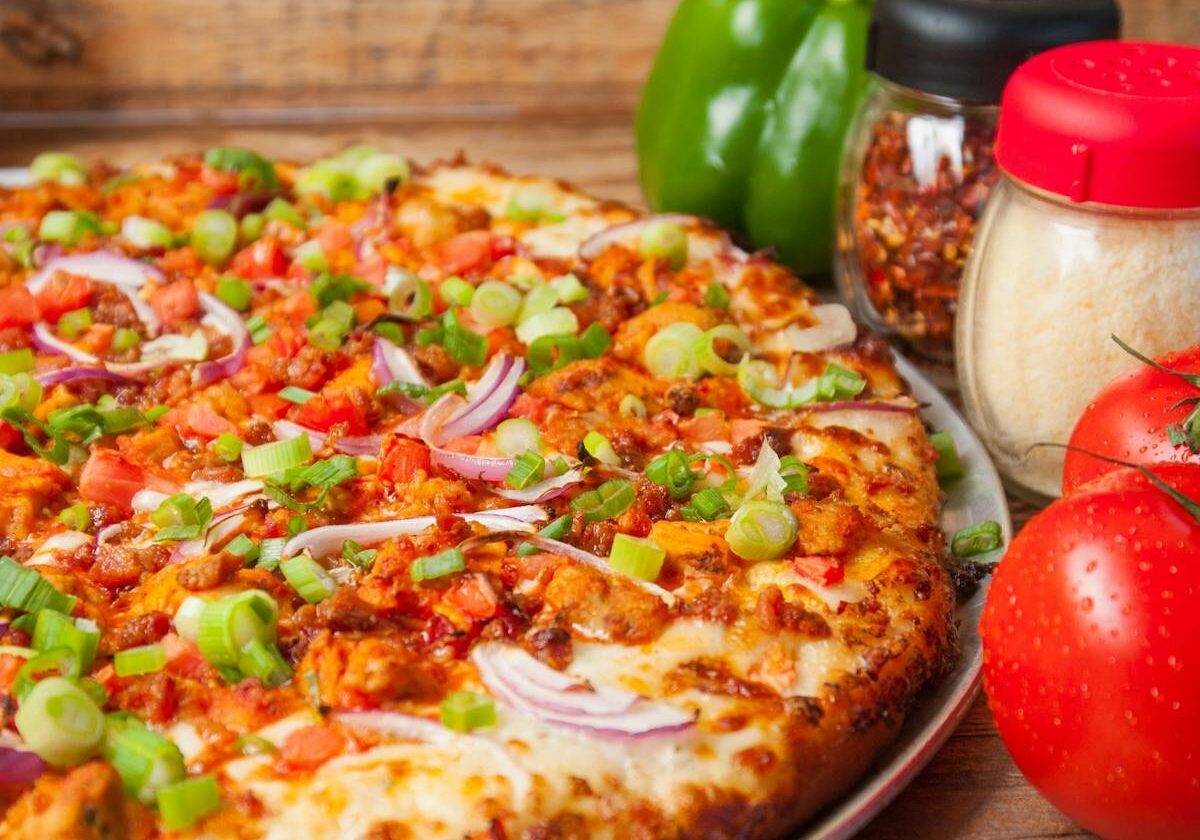 asset 29 A freshly baked pizza topped with vegetables and pepperoni.