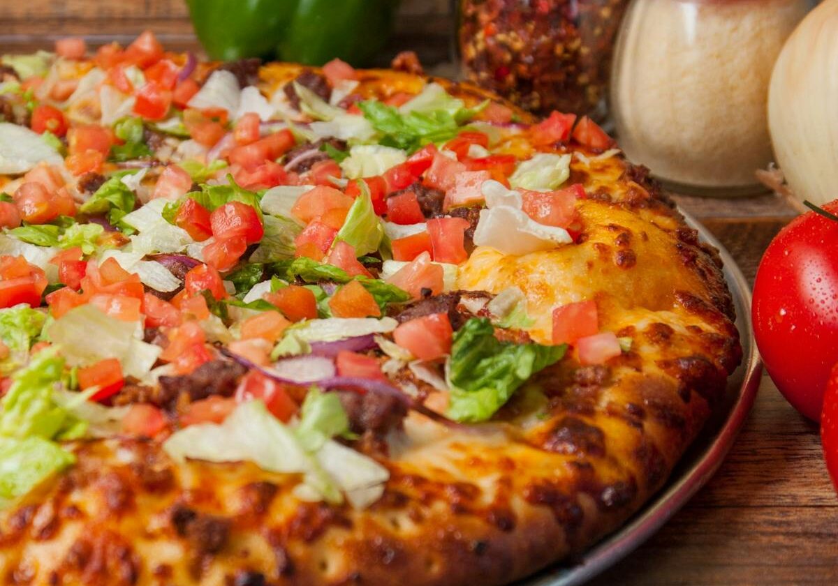 asset 33 A freshly baked pizza topped with vegetables and pepperoni.