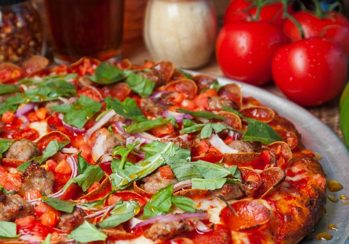 asset 35 A delicious pizza topped with fresh basil and tomatoes.