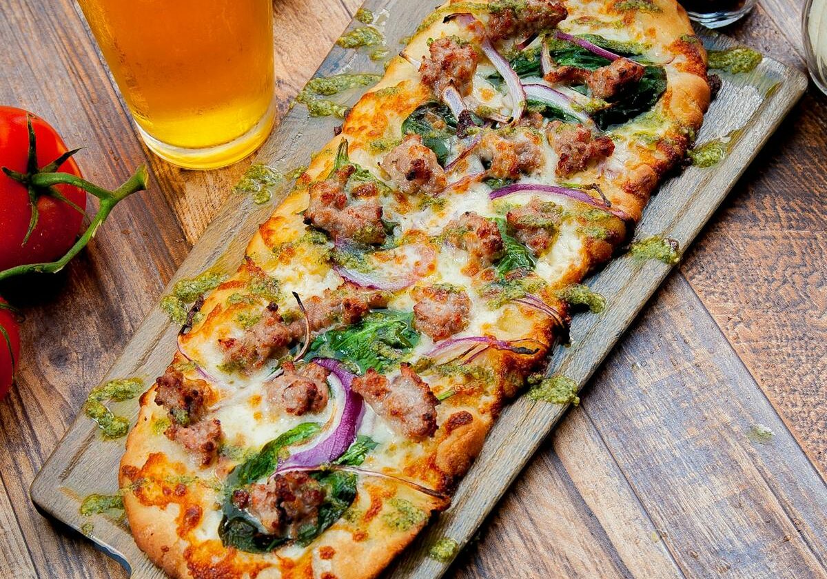 asset 42 A rectangular pizza topped with mushrooms, onions, and herbs.
