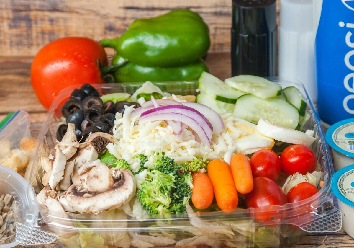 asset 46 A fresh vegetable salad with various colorful ingredients in a clear container.
