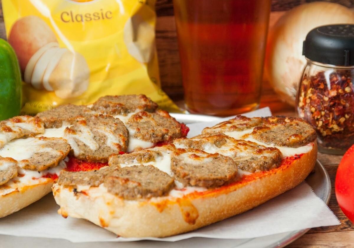 asset 51 Meatball sandwiches with melted cheese and chips.