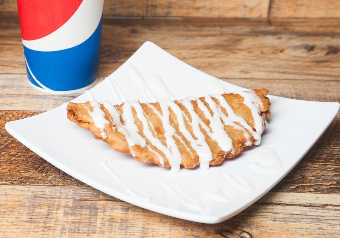 asset 56 A glazed apple turnover pastry on a white plate.