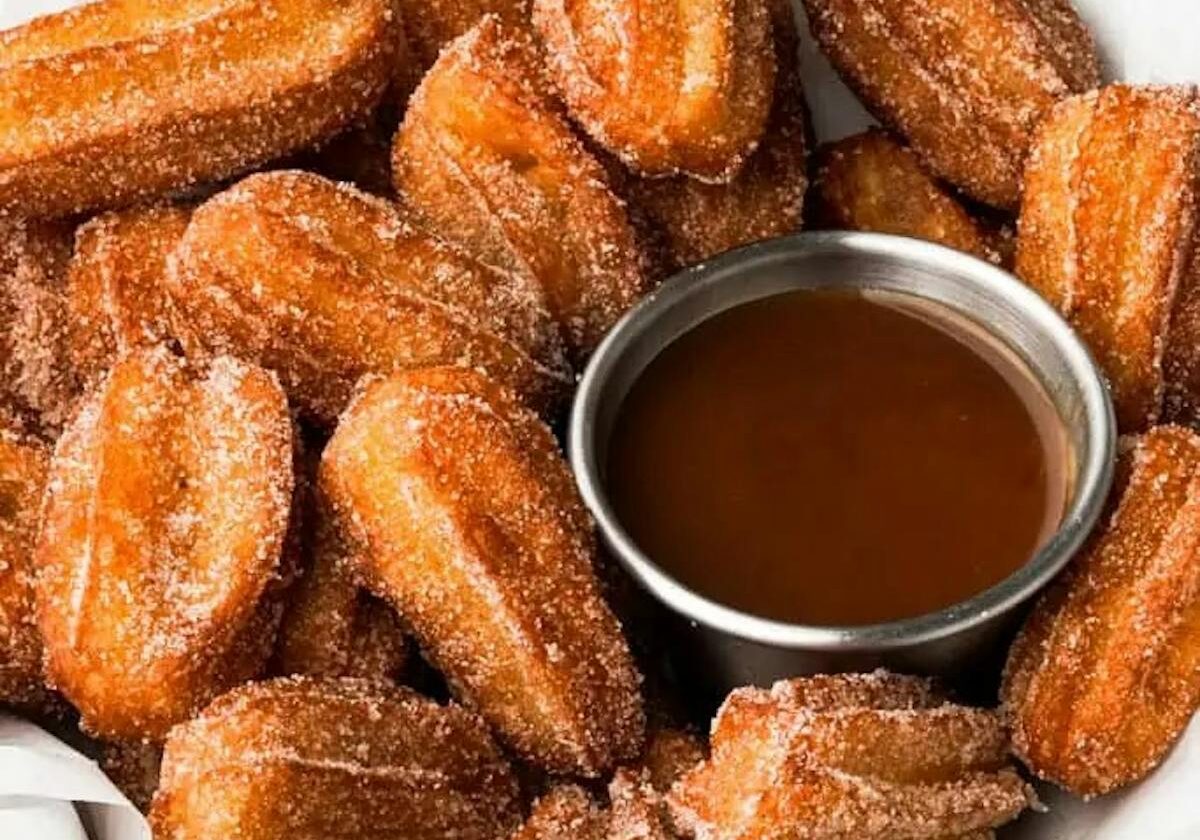 asset 58 A bowl of churros with chocolate dipping sauce.